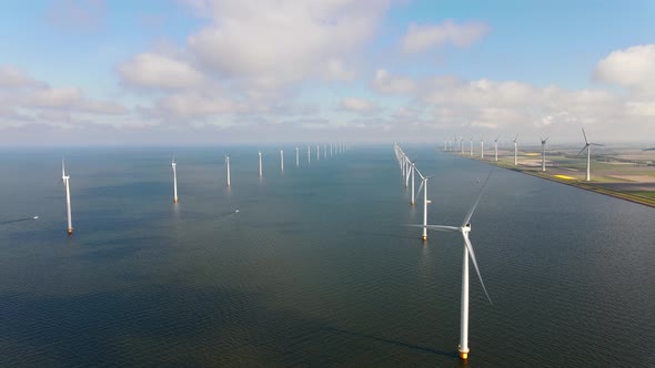 Offshore Windmill Park with Clouds and a Blue Sky Windmill Park in the Ocean Drone Aerial View with