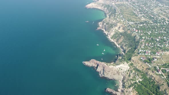 Aerial View From Above on Calm Azure Sea and Volcanic Rocky Shores