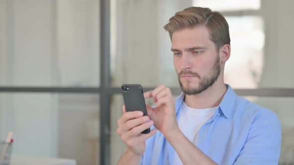 Portrait of Young Creative Man Using Smartphone