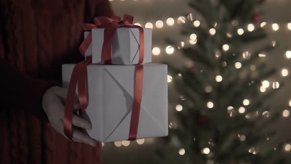 Female Hold White Gift Box With Christmas Tree Lights