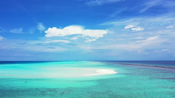 Tropical birds eye travel shot of a white paradise beach and aqua blue ocean background 