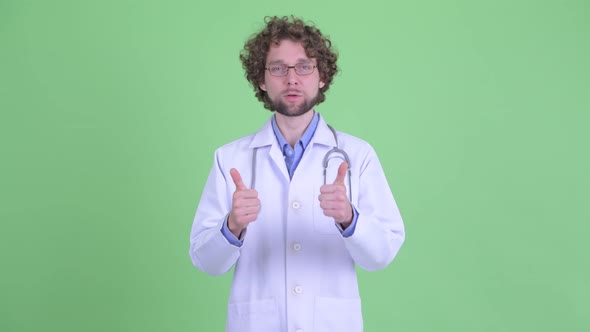 Happy Young Bearded Man Doctor Giving Thumbs Up and Looking Excited