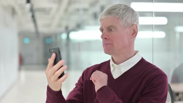 Middle Aged Man Having Loss on Smartphone