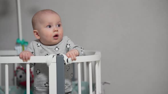 Baby Standing in a Crib at Home