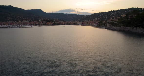 Gorgeous Sunset Reflecting on Ocean Surface on Coast of Portofino, Italy - Aerial Establishing Fligh