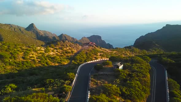 View From the Height of the Rocks Winding Road and Ocean in the Distance in the Masca at Sunset