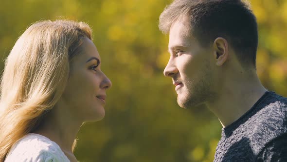 Young Couple Kissing, Man Hiding Faces With Autumn Leaf, Romantic Date, Closeup