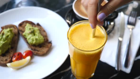 Freshly Squeezed Orange Juice Having Breakfast With Avocado Toasts And Coffee