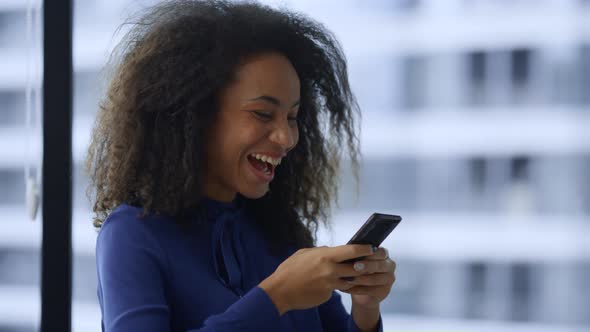 Excited African American Woman Celebrate Good News Work Promotion on Smartphone