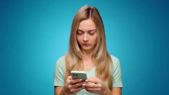 Young Woman Using Her Smartphone in Studio