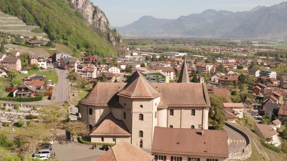 Flying up to beautiful old church in small Swiss town