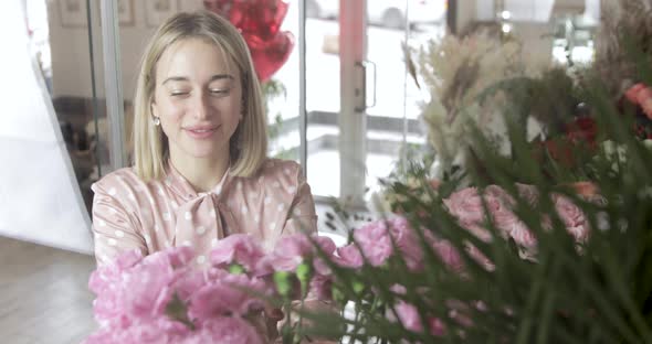 Portrait. Happy Florist Is Choosing Flowers For Bouquet. Flowers Fridge.