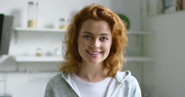 Portrait of Young Woman in Positive Mood at Home