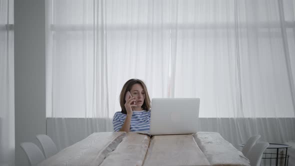 Woman use smartphone and laptop to work