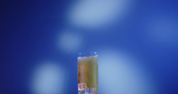 Ice cubes fall into an energy drink (could also be apple spritzer, beer, etc.)