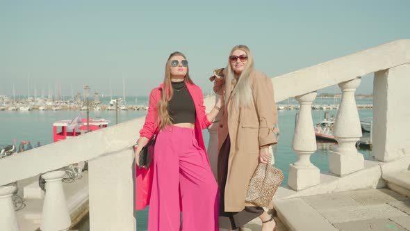 Young Women Enjoy Weather on Bridge Over Venetian Lagoon