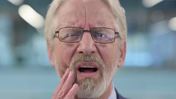 Close Up of Old Businessman with Toothache Cavity