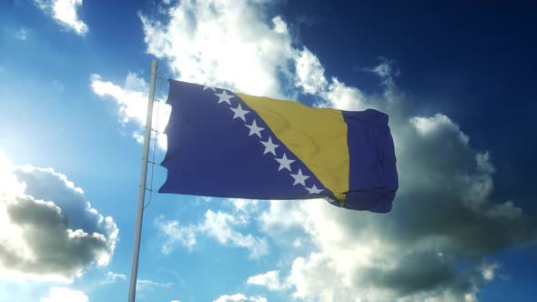 Flag of Bosnia and Herzegovina Waving at Wind Against Beautiful Blue Sky