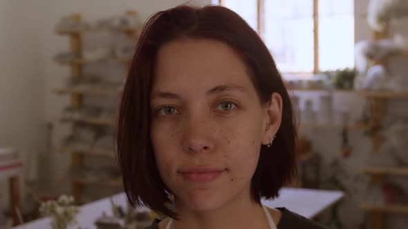 Young female potter working in her studio