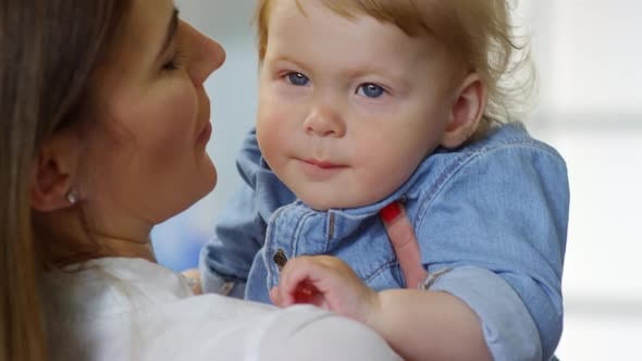 Blue-eyed Blond Baby with Doting Mom