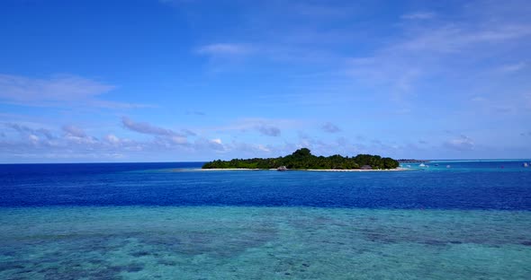 Daytime above clean view of a sunshine white sandy paradise beach and aqua blue water background 