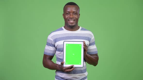 Young Happy African Man Showing Digital Tablet