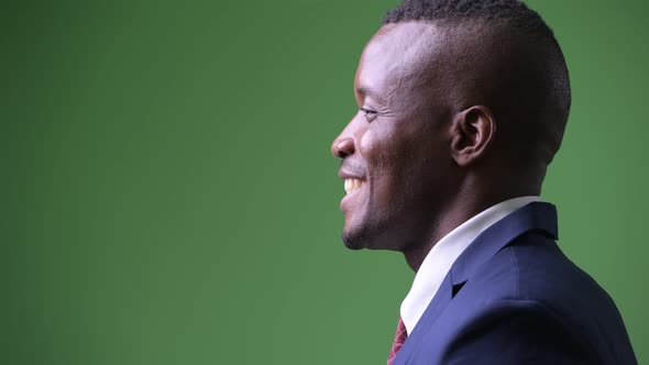 Profile View of Young African Businessman Smiling