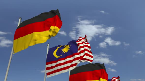 Flags of Malaysia and Germany Against Blue Sky