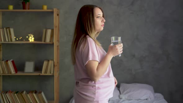 Young Pregnant Woman Drinking Water Healthy Lifestyle and Pregnancy Pure Mineral Water