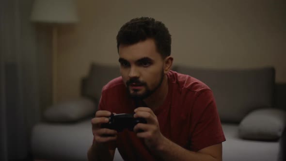 Single Man Playing Video Game at Home, Weekend Leisure, Gadget Addiction, Relax