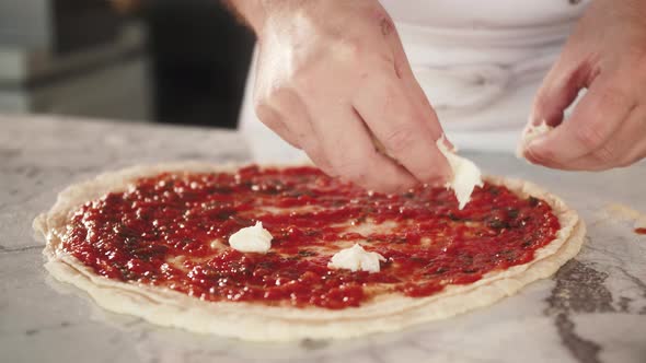 Italian Chef Making Margaritta Pizza with Tomato Sause and Mozzarella Traditional Food in Italy High