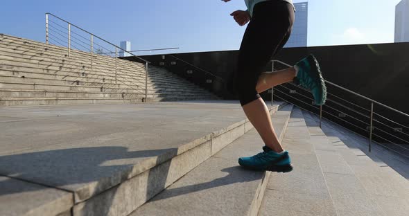 Fitness sports woman running up stairs in city