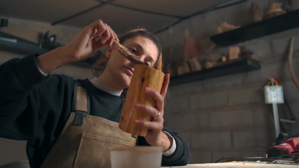 Focused artisan vanishing piece of wood in carpentry