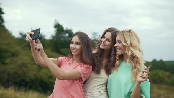 Beautiful Girls Taking Photos On Phone In Nature.