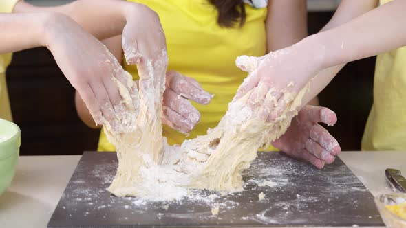 Children's Hands Close Up Knead Pizza Dough. Children Help Their Mother To Cook