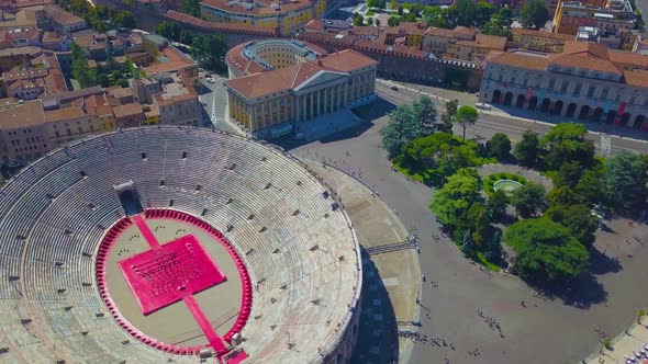 Aerial panoramic view of Arena di Verona, Italy. The drone flies in circle over the Arena and houses