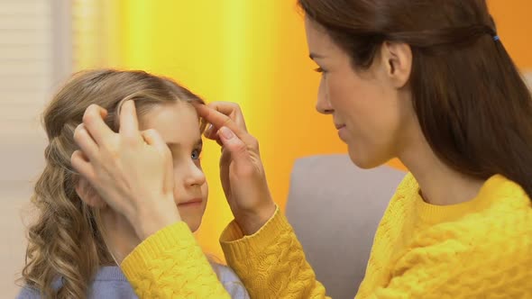 Beautiful Lady Mother Stroking Little Daughters Hair and Hugging Her, Happiness