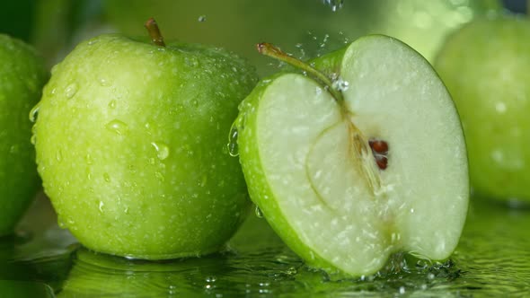 Super Slow Motion Shot of Water Splashing on Fresh Cutted Green Apple at 1000Fps