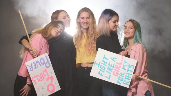 Smiling Happy Feminists Women Together in Smoky Space