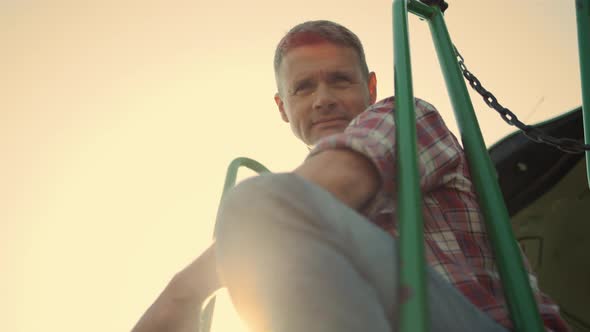 Driver Tractor Posing Sunlight at Clear Sky