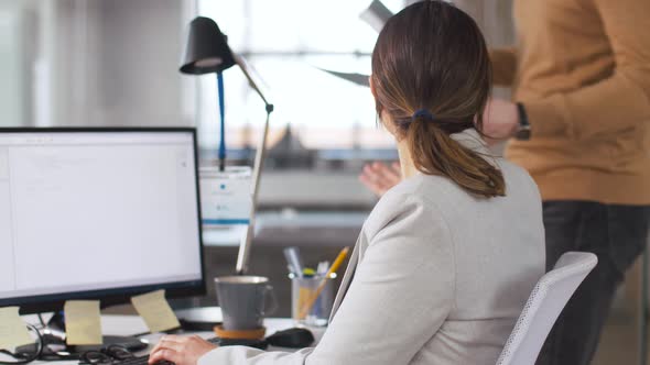 Programmer Taking Folder From Colleague at Office 8