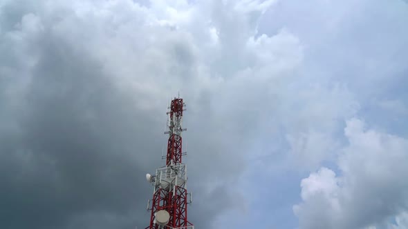 Large Telecommunication Tower Against Sky and Clouds in Background