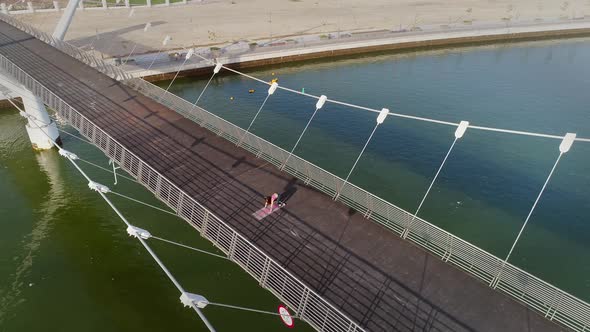 Aerial view of woman doing exercise in bridge on Abu Dhabi, U.A.E