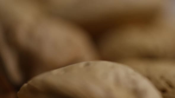 Cinematic, rotating shot of a variety of nuts on a white surface - NUTS MIXED 039