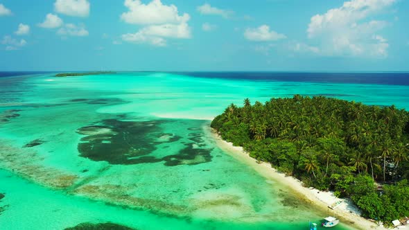 Beautiful aerial abstract shot of a white sandy paradise beach and blue water background in vibrant 