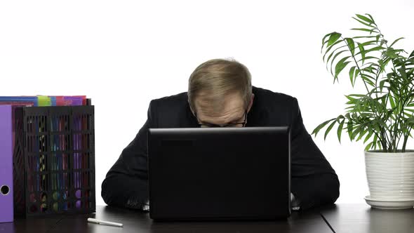 Businessman Manager Hides Behind a Laptop and Looks Out While Working in Office