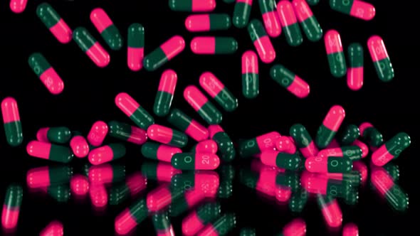 Super Slow Motion Shot of Falling Pink Pills on Black Background at 1000Fps.
