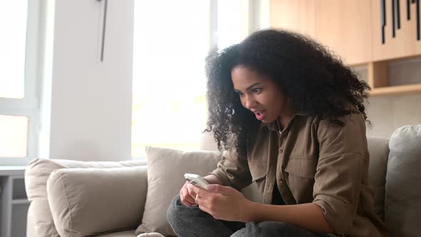 Overjoyed Woman Looking at Phone Screen Celebrating Success