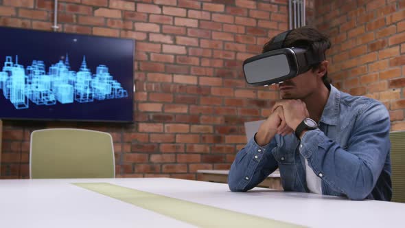 Creative businessman using virtual reality headset in modern office