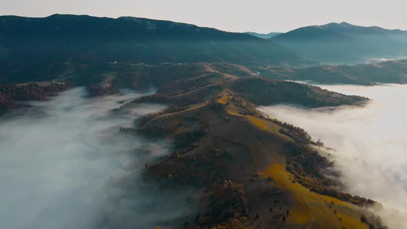 Drone Flight at Sunrise Over Beautiful Autumn Landscape of Mountain Range with Sea of Clouds in